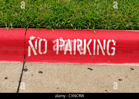 A no parking sign is painted on the curb. Stock Photo