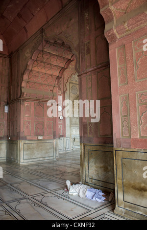 Man sleeping in the Jama Masjid main mosque, Old Delhi, India Stock Photo