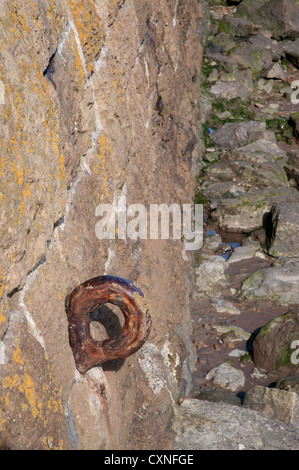 old rusted iron mooring ring set into old stone wall Stock Photo