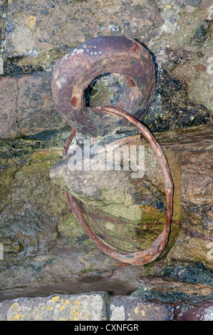 old rusted iron mooring ring set into old stone wall Stock Photo