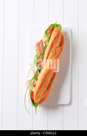 French bread filled with vegetables and chicken strips Stock Photo