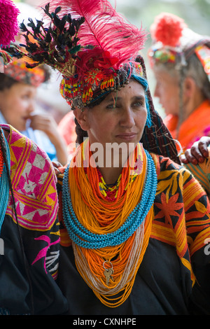 Kalash woman wearing a cowrie shell headdress (shushut) and coloured bead necklaces at the Joshi (Spring Festival), Rumbur Valley, Chitral, Khyber-Pakhtunkhwa, Pakistan Stock Photo