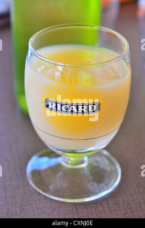 A glass of Ricard aperitif - the iconic drink of Provence, an anise-flavoured liqour (pastis ) taken to start a meal,Saintes Maries de la Mer, France Stock Photo