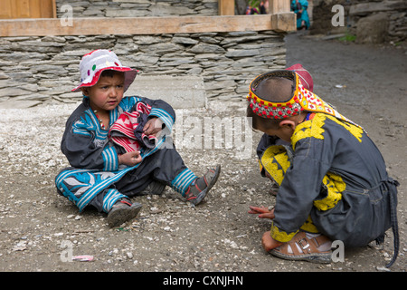 Kalash children playing in the street of the village of  Balanguru, Rumbur Valley, Chitral, Khyber-Pakhtunkhwa, Pakistan Stock Photo