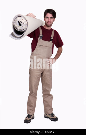 Man with a roll of carpet Stock Photo