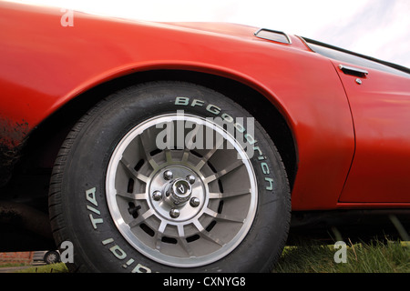 Close-up BF Goodrich big tyre on 1970's classic red Buick American Muscle car, Suffolk, UK Stock Photo