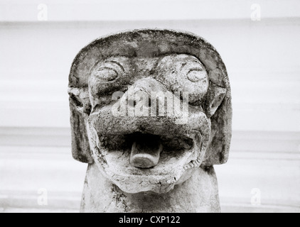 Dog sculpture guarding Buddhist temple Wat Phra Singh in Chiang Mai in Thailand in Far east Southeast Asia. Buddhism Religion Religious Travel b&w Stock Photo