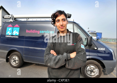 Portrait of a young plumbing apprentice in front of her work van. Stock Photo