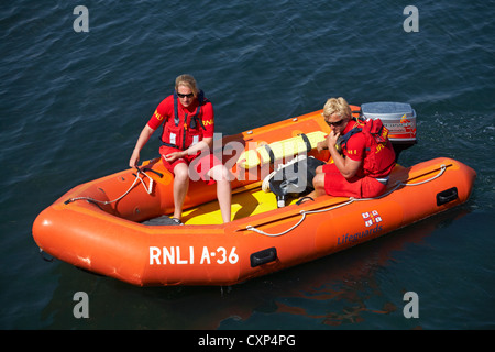 RNLI lifeguards patrolling in dinghy at Weymouth, Dorset UK in July Stock Photo