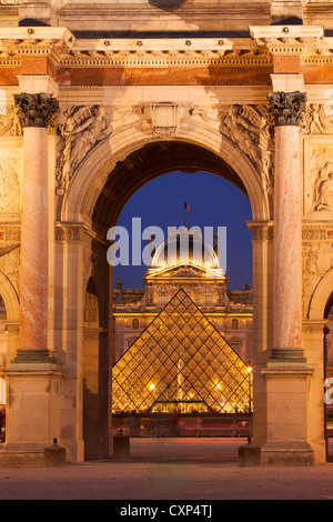 Musee du Louvre viewed through the archway of Arc de Triomphe du Carrousel, Paris France Stock Photo