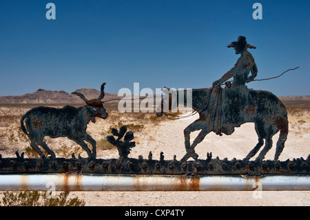 Cowboy and steer at wrought iron sign, ranch entrance in Chihuahuan Desert near Alpine, Texas, USA Stock Photo