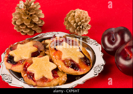 Fruit pies on a silver plate on red Stock Photo