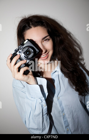 Young woman / teenager with camera Stock Photo