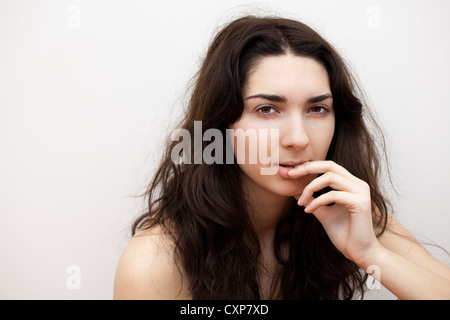 Young woman with worried expression Stock Photo