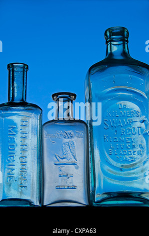 Morning backlighting on display of antique medicine bottles from the US. Stock Photo