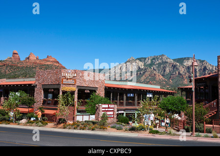 Shops on Main Street with red rocks in the background, downtown, Sedona, Arizona, United States of America Stock Photo