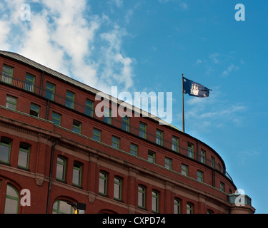 Flag of Free and Hanseatic City of Hamburg (Freie und Hansestadt Hamburg), flying and wavering high on the building. Stock Photo