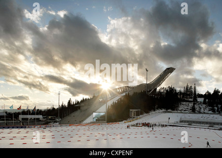 Holmenkollen Ski Jump, Holmenkollen, Norway. Architect: JDS Architects, 2011. View of sun setting behind jump. Stock Photo