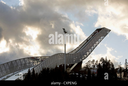 Holmenkollen Ski Jump, Holmenkollen, Norway. Architect: JDS Architects, 2011. View of sun setting behind jump. Stock Photo