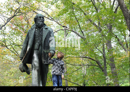 A statue of Walt Whitman stands atop a boulder next to the Appalachian Trail at Bear Mountain State Park in New York State. Stock Photo
