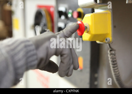 Factory worker pushing a button Stock Photo