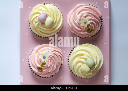 four pink and white cupcakes ready for Easter Stock Photo