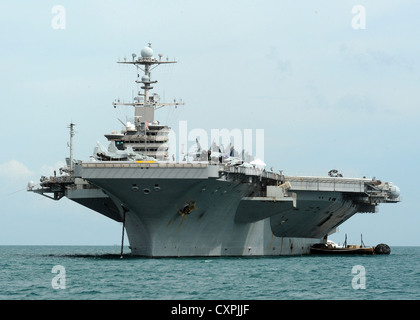 The Nimitz-class aircraft carrier USS John C. Stennis (CVN 74) anchors out for a port visit to Thailand. John C. Stennis is returning to the U.S. 7th and 5th Fleet areas of responsibility four months ahead of schedule in order to maintain combatant commander requirements Navy assets in the region. Stock Photo