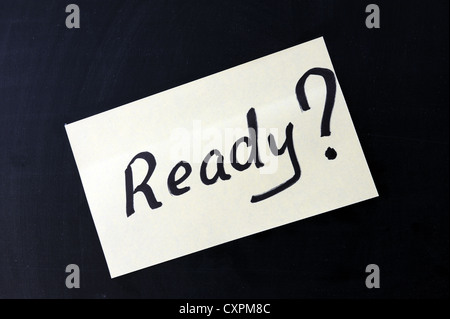 a notepaper which writes "Ready ?" on a chalkboard Stock Photo