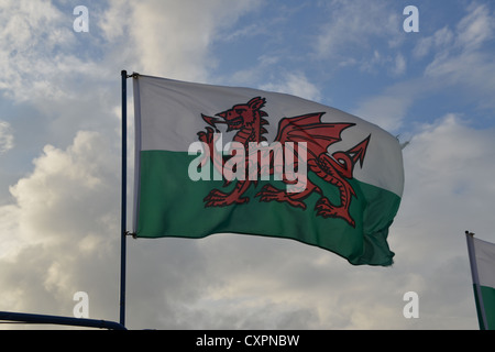 Welsh flag flying against blue sky Stock Photo