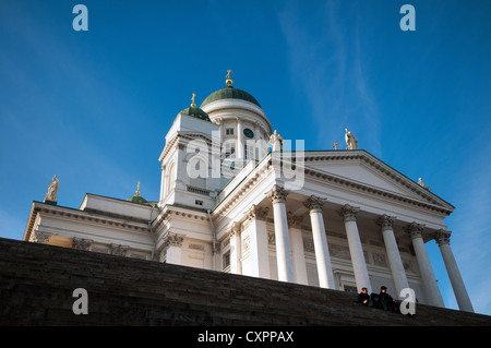 Couple sitting on the steps in front of Helsinki Cathedral in Senate Square, Helsinki, Finland Stock Photo