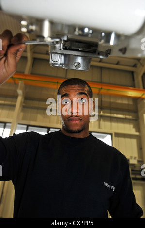 Young Apprentice training to be a technician for a Power company Stock Photo