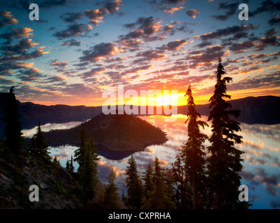 Sunrise on Crater Lake with Wizard Island. Crater Lake National Park. Oregon reflection,sun,silhouette,forest, Stock Photo