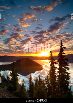 Sunrise on Crater Lake with Wizard Island. Crater Lake National Park. Oregon reflection,sun,silhouette,forest, Stock Photo