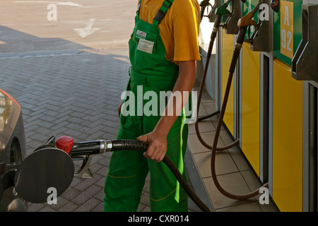 Attendant filling car with petrol, Lviv, Ukraine Stock Photo