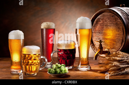 Beer barrel and draft beer by the glass. Dark background. Stock Photo