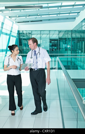 Doctors with medical records on digital tablet Stock Photo