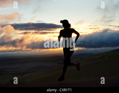 Woman running outside, silhouette Stock Photo