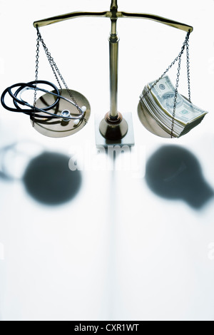 Weighing scales with stethoscope and banknotes Stock Photo