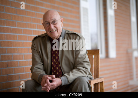 Man sitting on chair, portrait Stock Photo