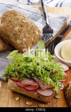 sunflower seed roll with salami and sliced radish Stock Photo