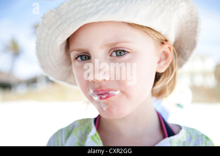 Little girl with ice cream around her mouth Stock Photo