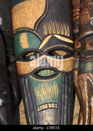 Decorated hand made wooden mask carved from the wood of an African tree Stock Photo