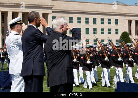 US President Barack Obama, Secretary of Defense Robert Gates and Chairman of the Joint Chiefs of Staff Admiral Mike Mullen salute as troops parade during the Armed Forces Farewell Tribute in honor of Secretary Gates at the Pentagon June 30, 2011 in Arlington, Virginia. Stock Photo