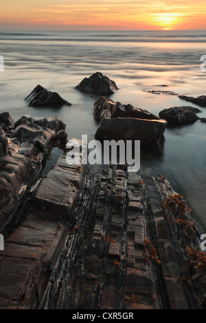 Summer sunset over the rocky shores of Sandymouth Bay near Bude in Cornwall, England Stock Photo