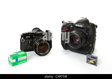 40 years of professional cameras, professional SLR Canon F-1, 1972, next to digital SLR Nikon D4, 2012, Fuji slide film and Stock Photo