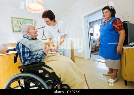 Ambulatory care of the German Red Cross, nurse Anke Lehmann attending an old married couple, as she does every morning, helping Stock Photo