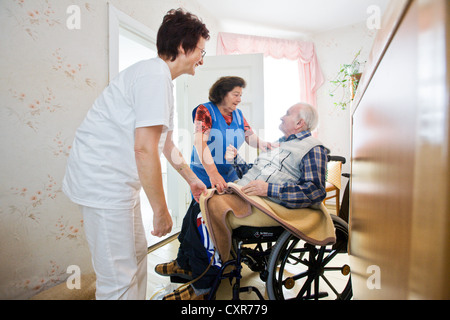 Ambulatory care of the German Red Cross, nurse Anke Lehmann attending an old married couple, as she does every morning, helping Stock Photo