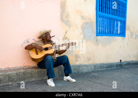 Street musician playing guitar in the historic town of Santiago de Cuba, Cuba, Central America Stock Photo
