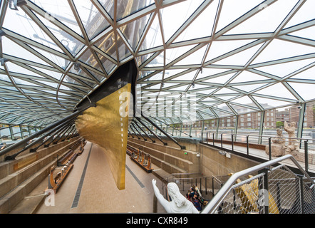 The golden hull of the Cutty Sark an original tea clipper vessel from the 1800's, showing roman numeration on the bow scales Stock Photo