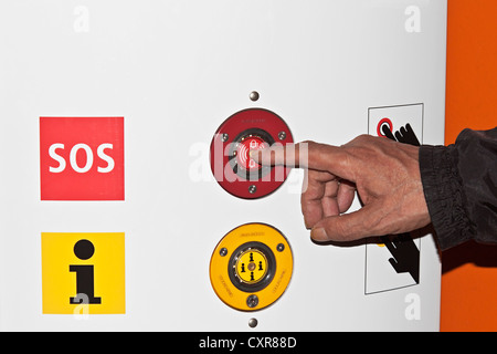 A man's hand pressing an alarm button, SOS, SOS column Stock Photo